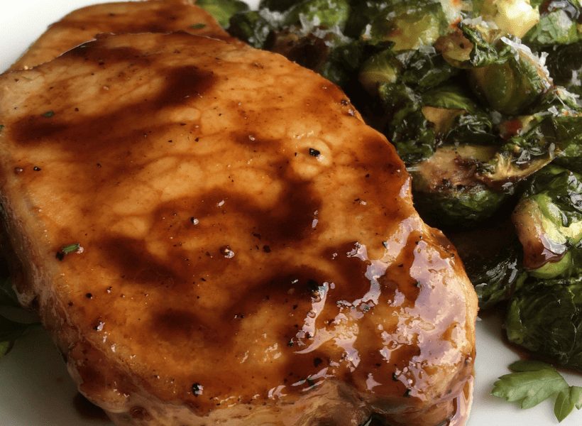maple balsamic pork chops on plate with brussels sprouts