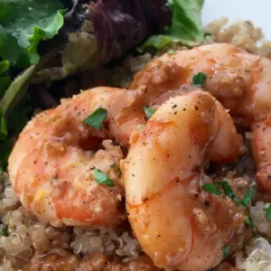 shrimp with quinoa and salad on plate