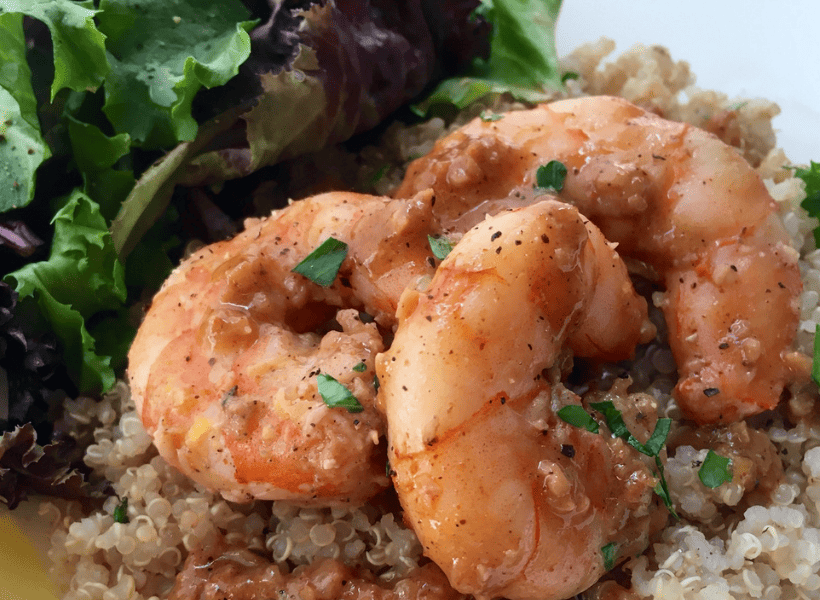 shrimp with quinoa and salad on plate