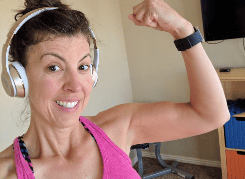 stephanie with headphones and flexing biceps