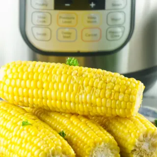 4 ears of corn ready to eat placed in front of instant pot