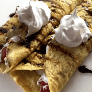 two gluten free crepes filled with strawberries, whipped cream and chocolate