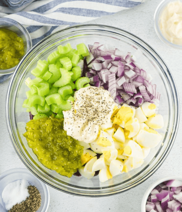 eggs, red onions, celery, mayo, salt and pepper for kidney salad in a bowl to be mixed