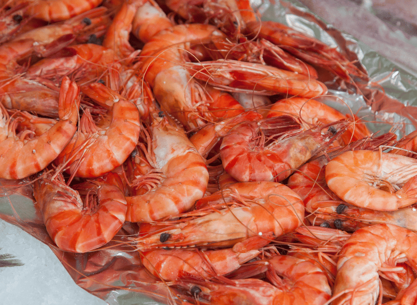 cooked shrimp in a pile with shells