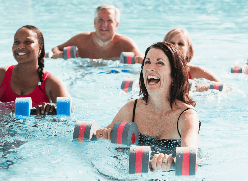 group of people with water dumbbells doing water aerobics