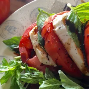 sliced tomatoes with balsamic glaze, mozzarella and fresh basil