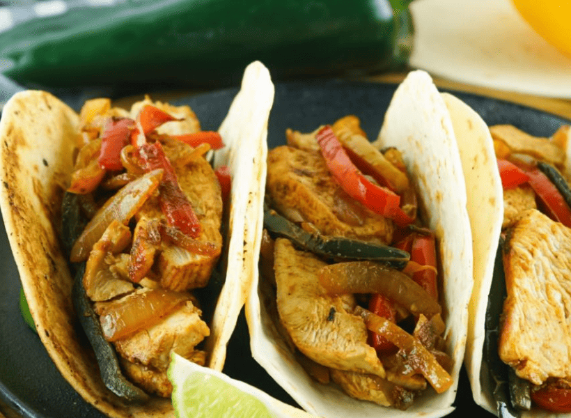2 flour tacos with chicken fajitas on plate