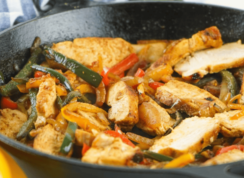 cooked chicken fajitas in cast iron skillet