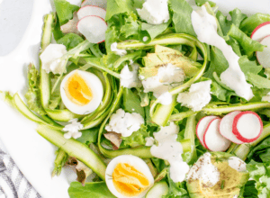 asparagus salad with eggs, radishes and avocado and dressing