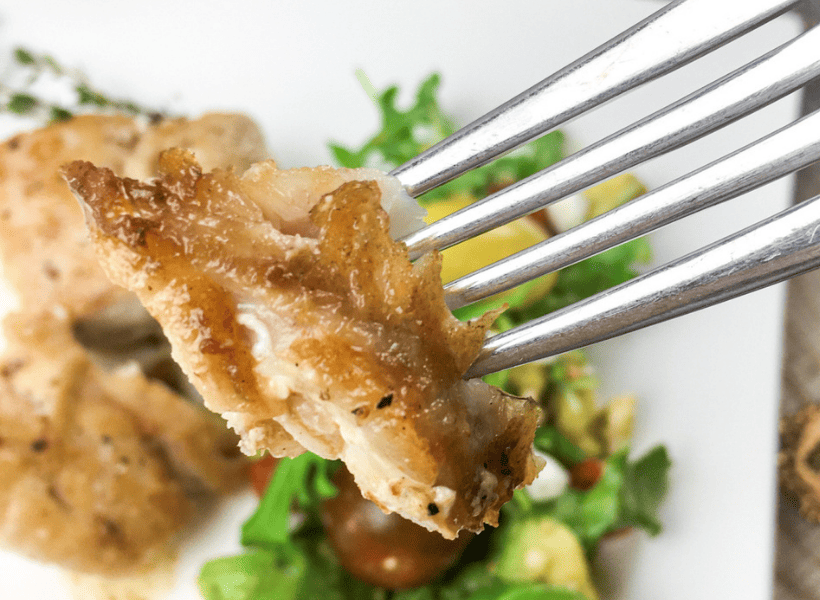 bite of fried grouper with lemon on fork