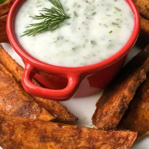 red dish with greek yogurt with potato wedges