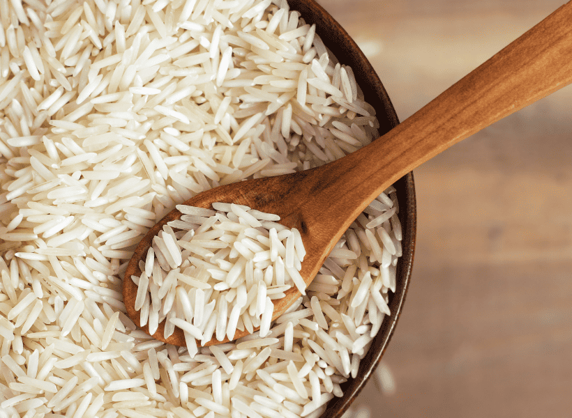 bowl of basmati rice with wooden spoon