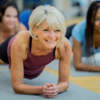 woman over 40 doing core workout plank