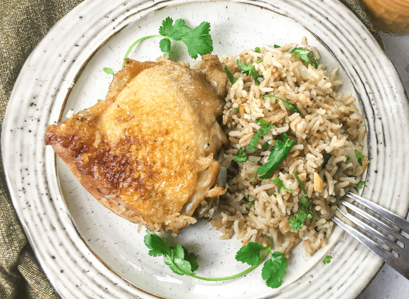 roasted chicken with rice on a plate
