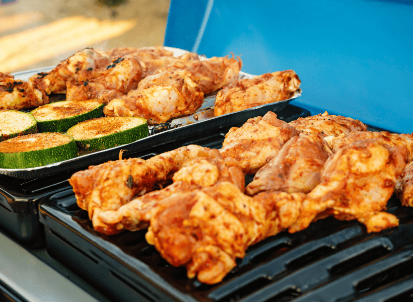 gas grill with chicken and veggies