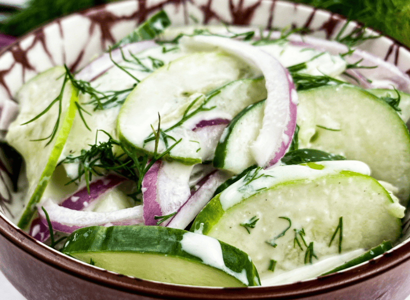 cucumber salad with dill dressing in bowl