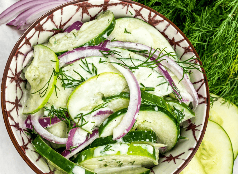 cucumbers red onions with dill dressing and dill sprinkled on top