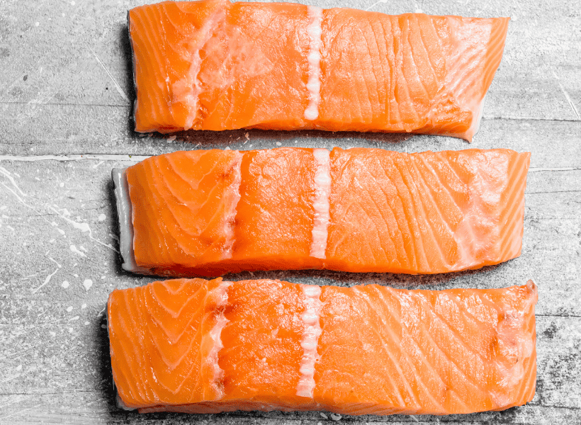 raw salmon on cutting board