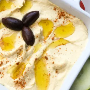 homemade garlic hummus with kalamata olives garnishment