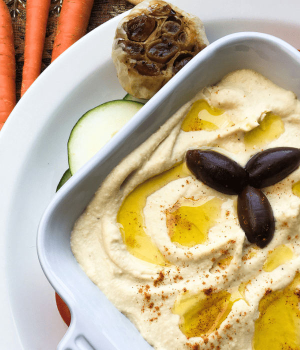 garlic hummus with cayenne pepper sprinkled on top
