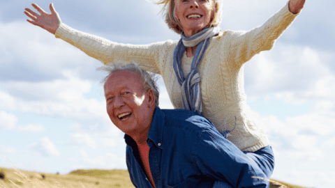 man and woman outside with man carrying woman on his back