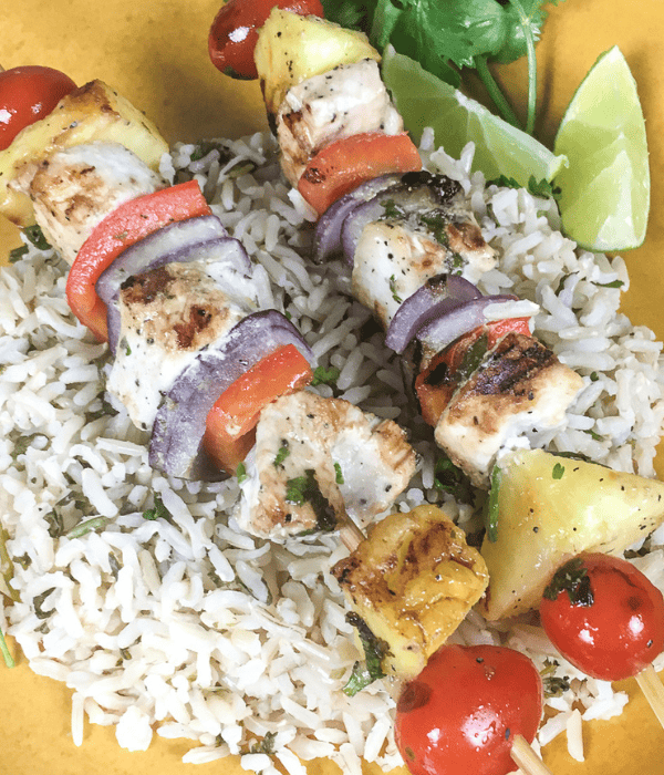 swordfish kabobs on bed of rice on plate
