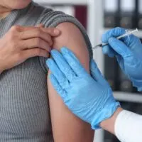 Cancer Patients on Immunotherapy See Double Survival Rates After COVID Shots Asian,Woman,Receives,Flu,Vaccine,At,Hospital,Hands,Of,A
