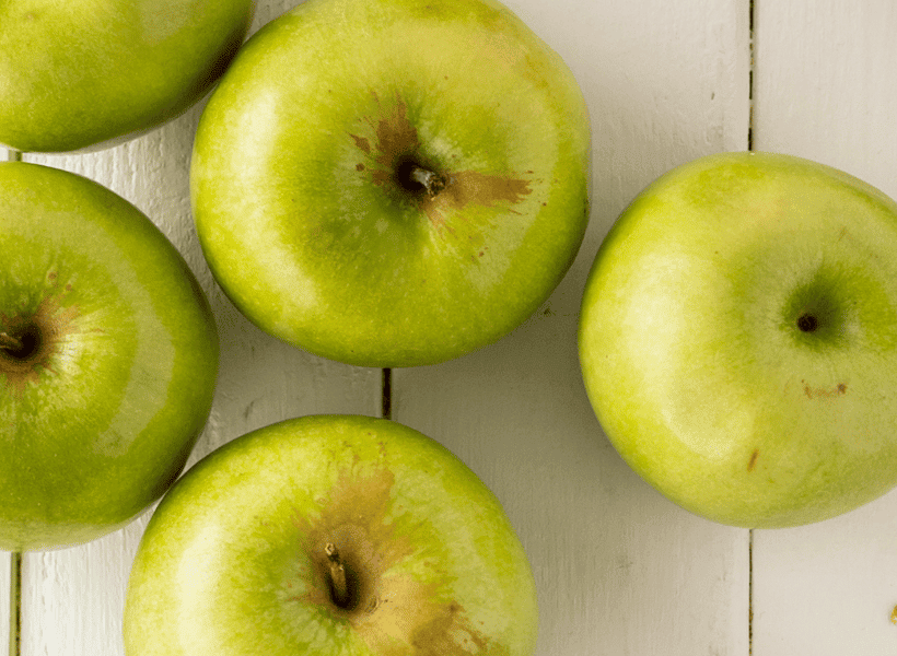 green apples on cutting board