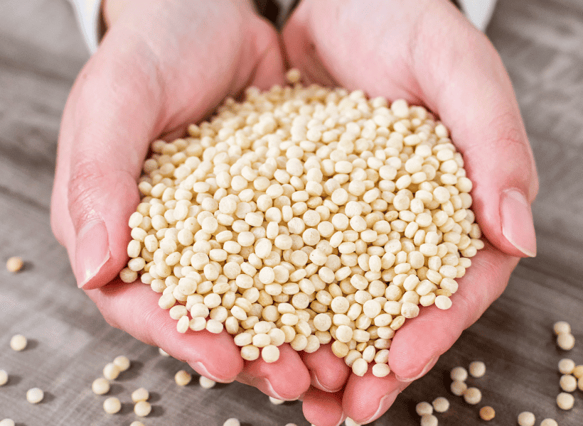 woman with handful of israeli pearl couscous