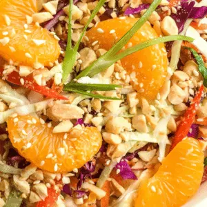 chinese cabbage salad in serving platter with mandarin oranges and peanut dressing