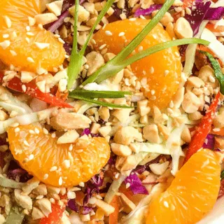 chinese cabbage salad in serving platter with mandarin oranges and peanut dressing