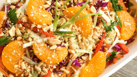 chinese cabbage salad in serving platter with mandarin oranges and peanut dressing