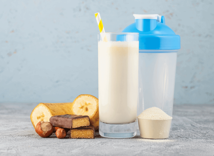 shaker bottle, shake in a glass, banana and protein powder on counter