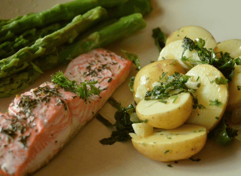 parsley potatoes with salmon and asparagus on a plate