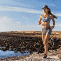 lady running outside by a lake
