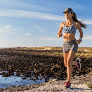 lady running outside by a lake