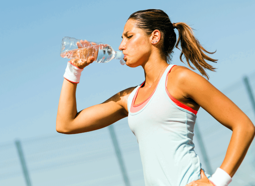 lady drinking water after running