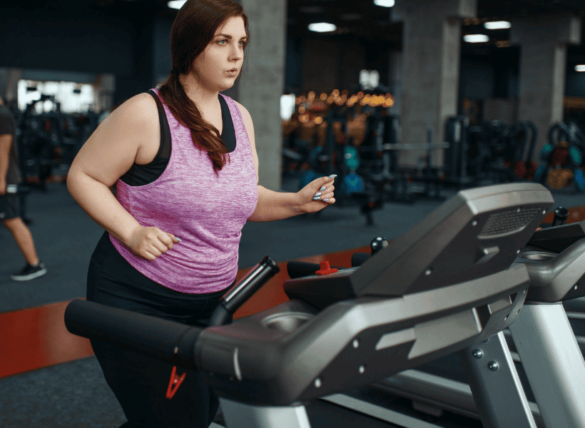 obese woman doing treadmill workout