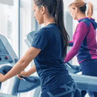 gym with treadmills and ladies walking on treadmills