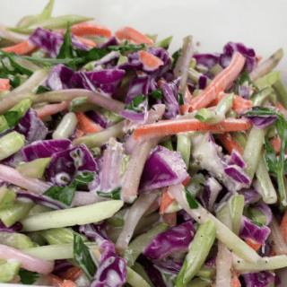 broccoli slaw in large white serving dish