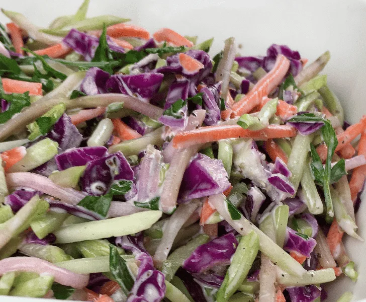 broccoli slaw in large white serving dish