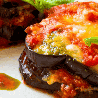serving of eggplant parmesan without breadcrumbs on a white plate