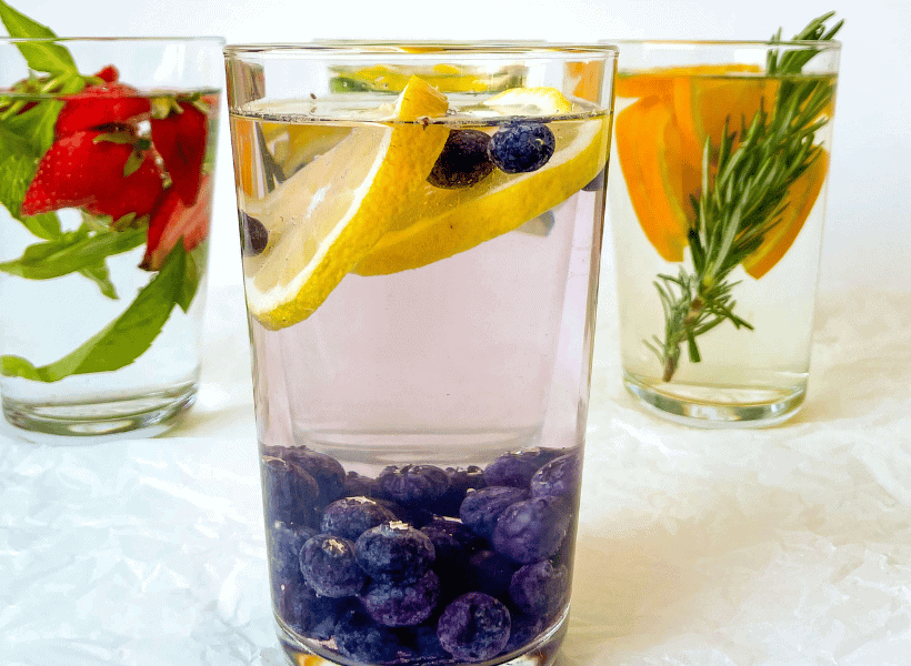 glass with water, blueberries and lemon