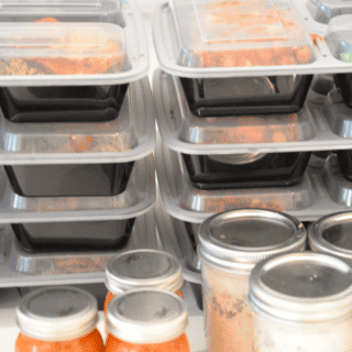 two stacks of meal prepping containers filled with food