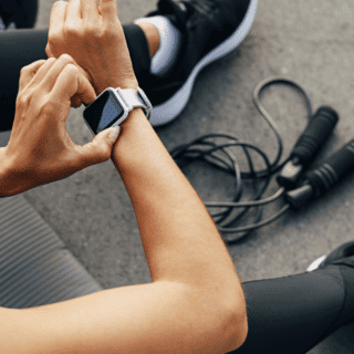 woman in fitness clothing adjusting her apple watch