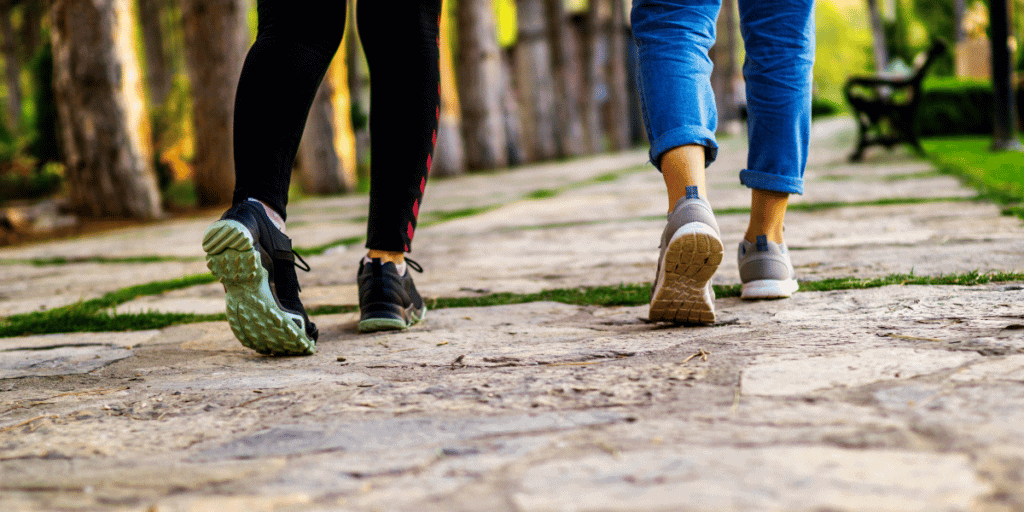 two ladies walking away with close up of legs and shoes