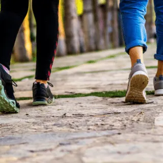 two ladies walking away with close up of legs and shoes