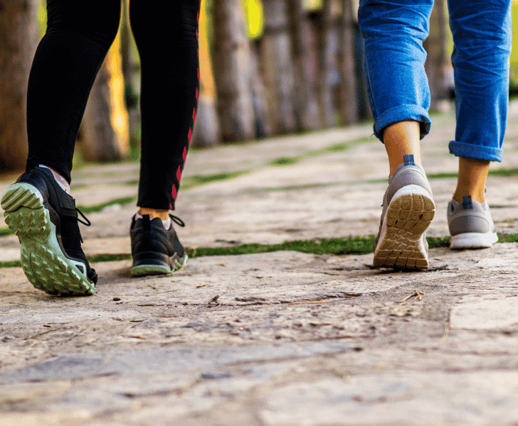 two ladies walking away with close up of legs and shoes