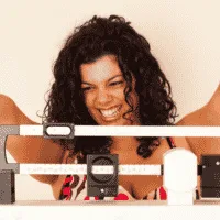 woman happy on scale weighing herself