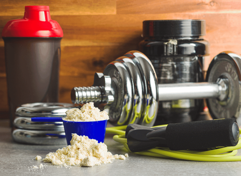 workout equipment and protein powder on a table